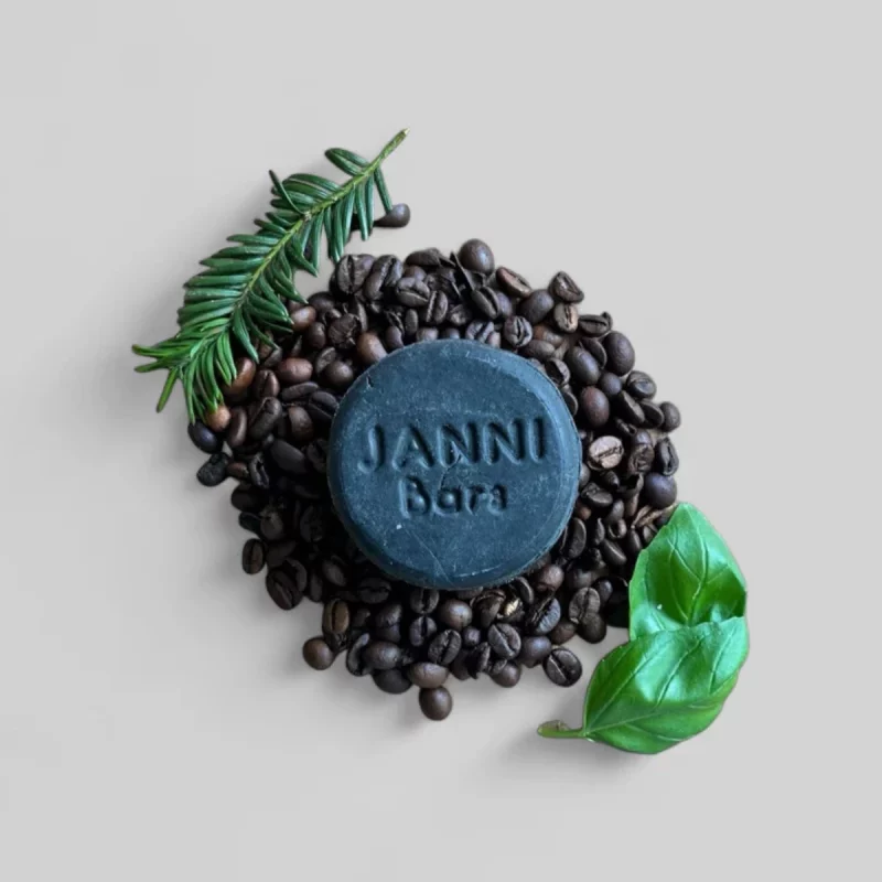 Janni Bars charcoal shampoo bar with coffee beans and herbs flat lay